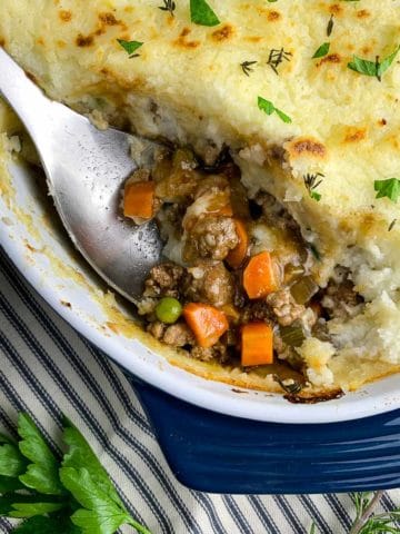 Close up view of homemade Shepherd's Pie with a serving spoon