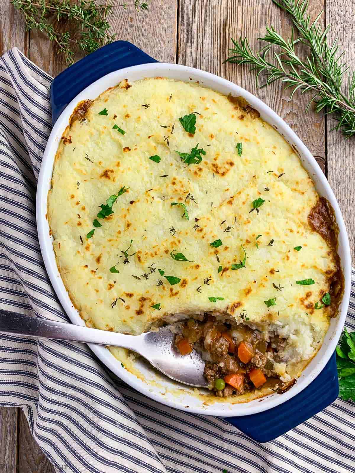 Shepherd's Pie with a serving spoon showing filling inside.