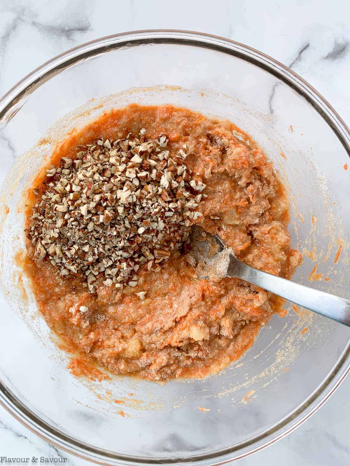 Adding pecans to cupcake batter.