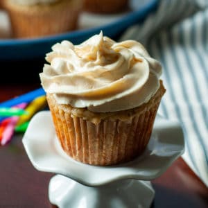 A single banana cupcake on a pedestal stand