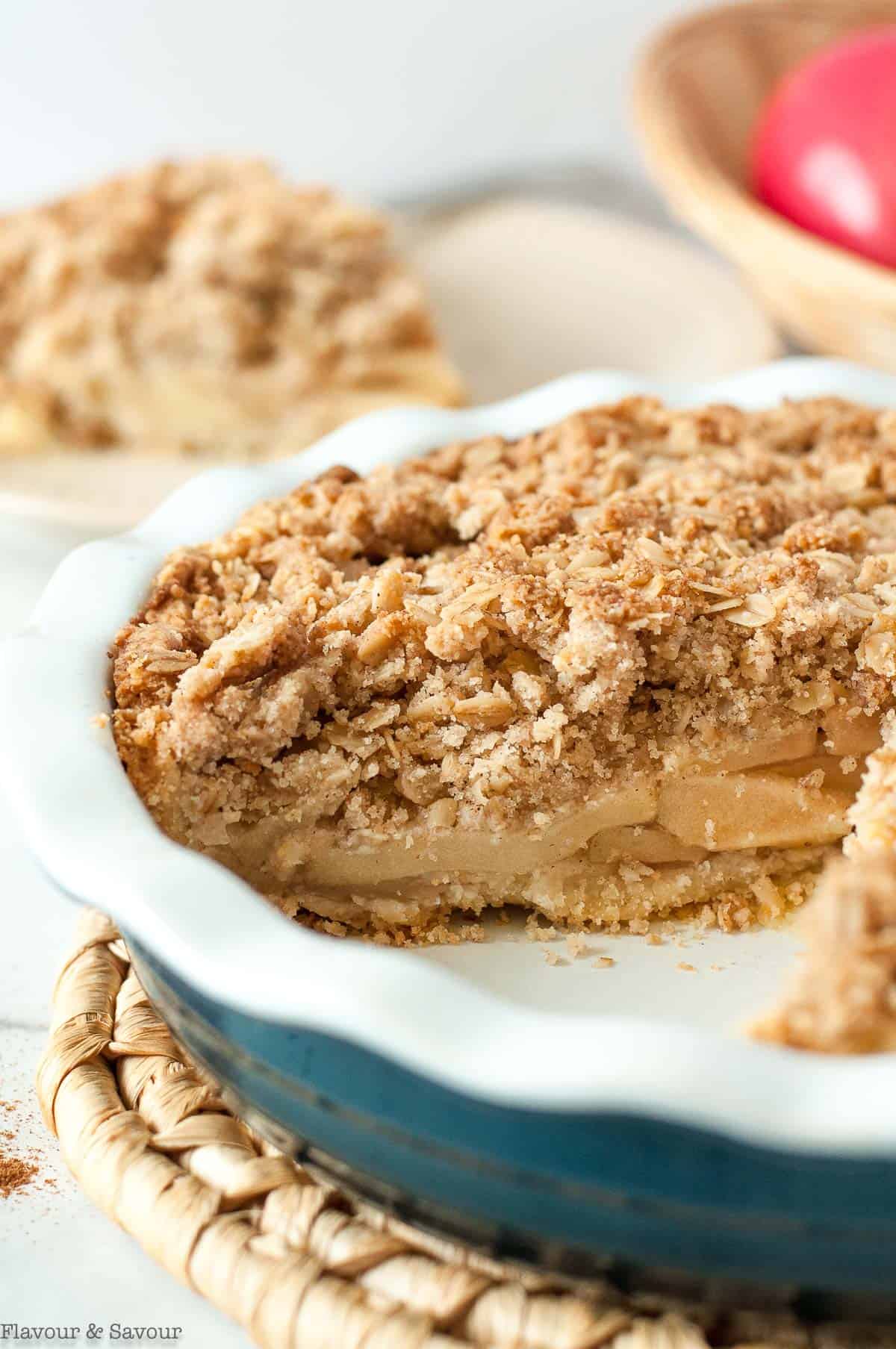 Apple Pie in a pie plate with a slice removed.