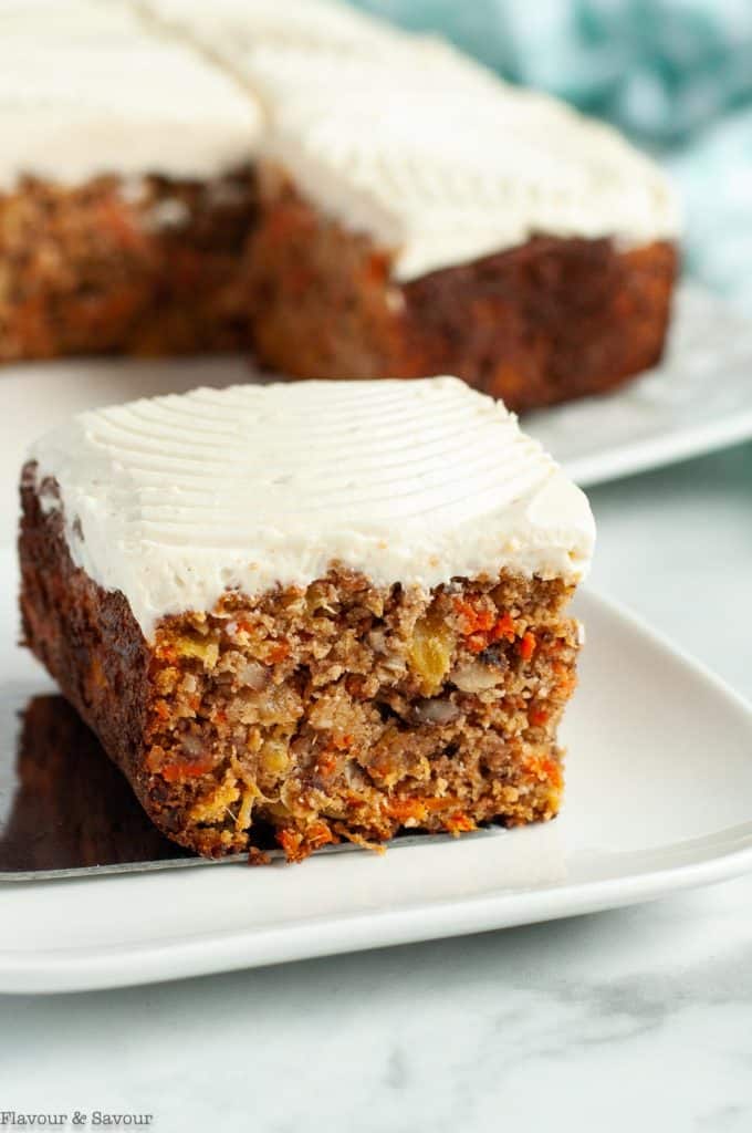 close up view of a piece of carrot cake with cream cheese frosting