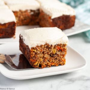 A square of grain-free carrot cake with cream cheese frosting .