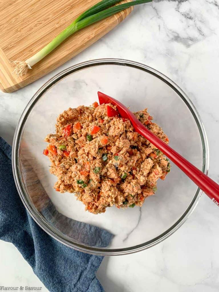 Salmon patty mixture in a bowl with a spatula