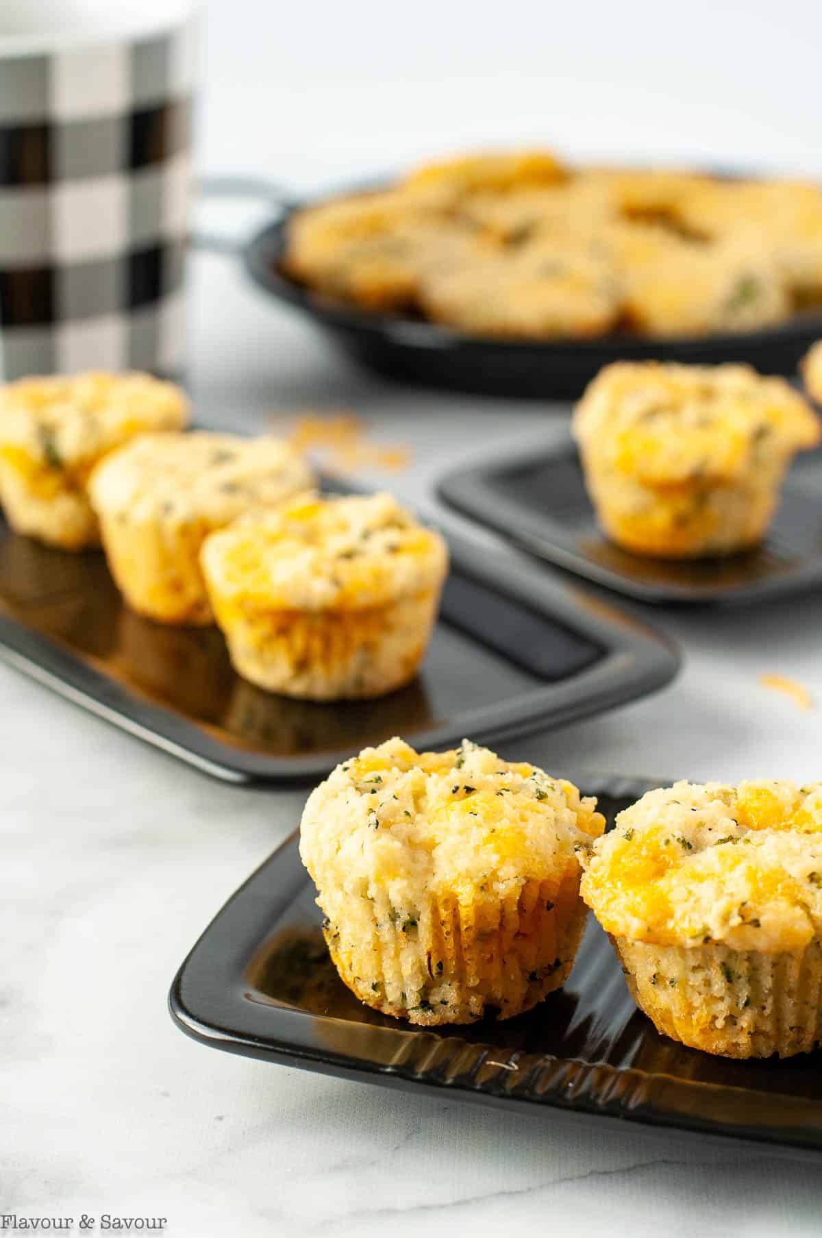 Mini Broccoli Cheese Muffins on small black plates.