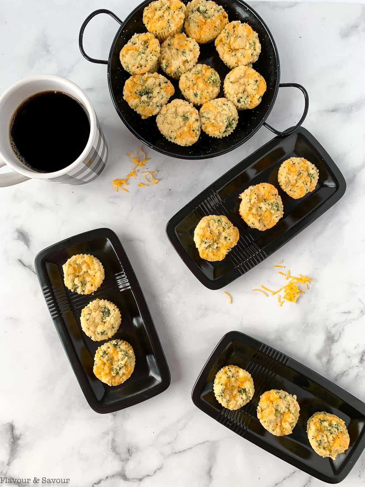 Gluten-free Broccoli Cheddar Muffins on small black serving plates.