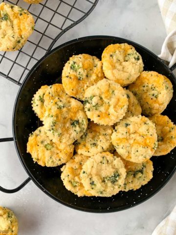 Overhead view of a black serving dish with mini Broccoli Cheese Muffins