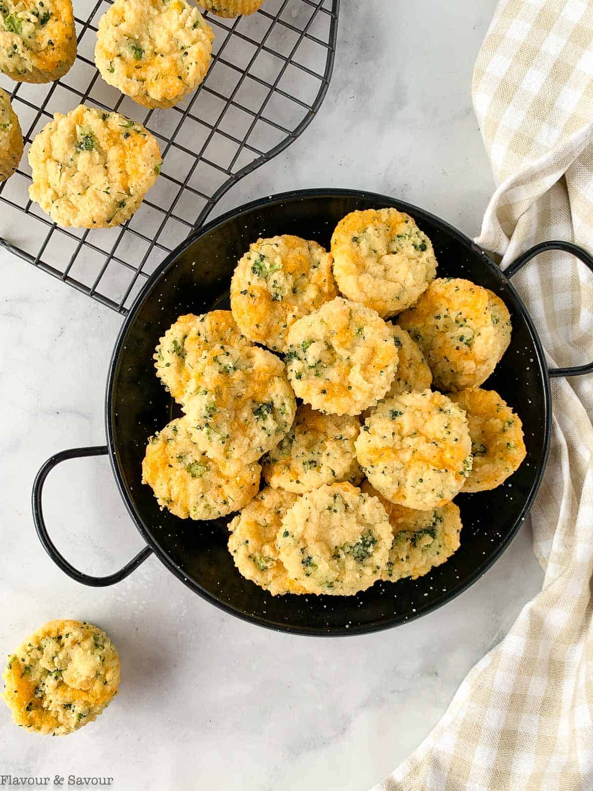 Broccoli Cheddar muffins in a black serving dish.