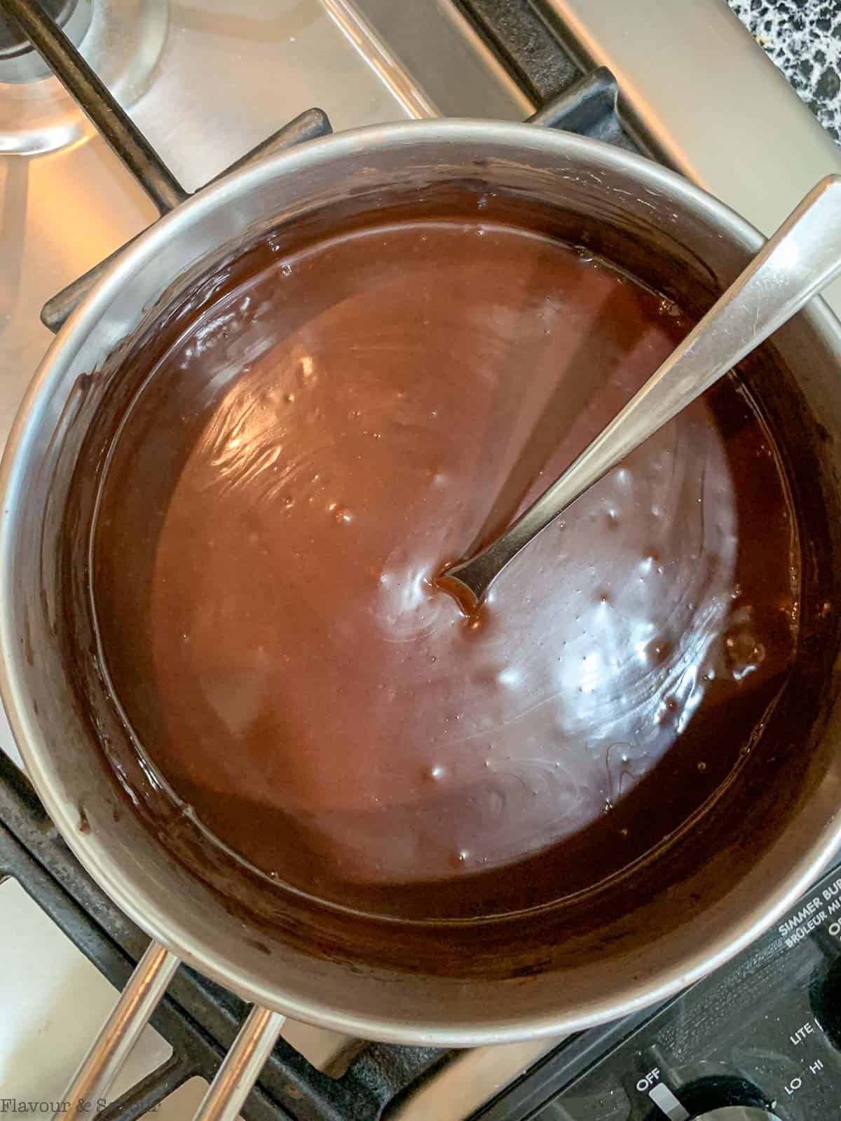 Heating oat milk pudding in a sauceapn.