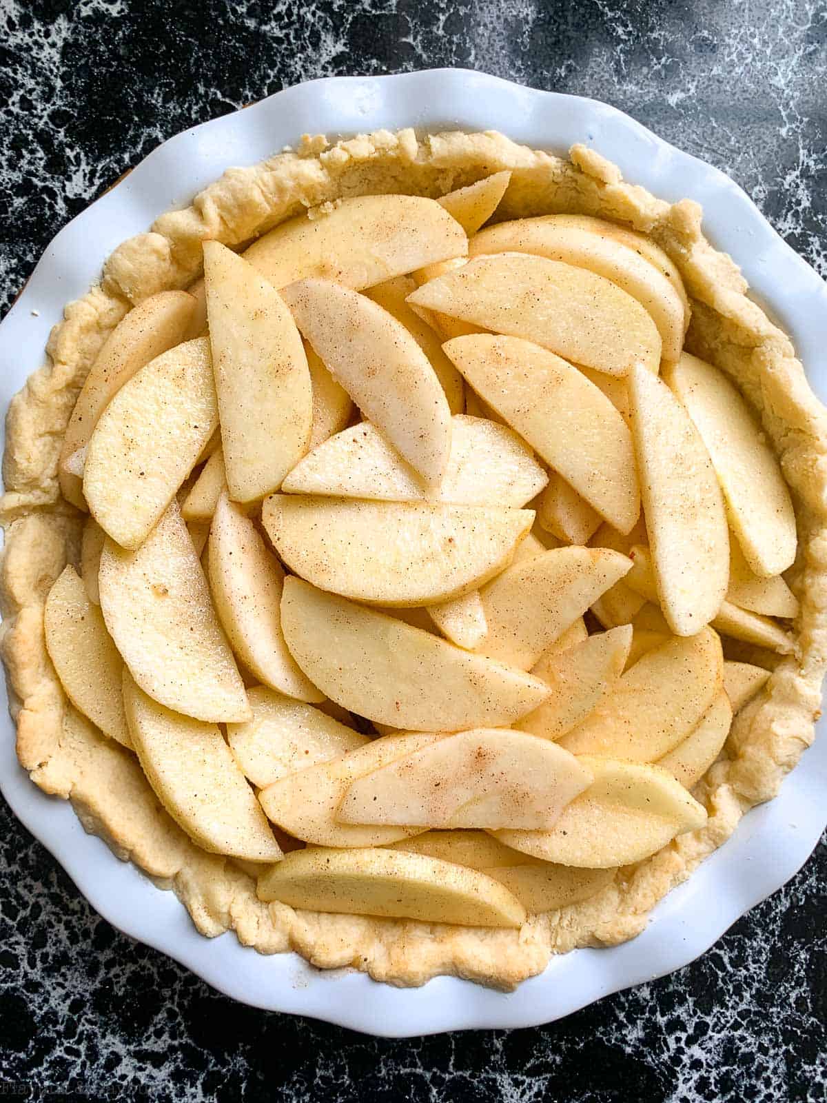 Sliced apples in pie crust.