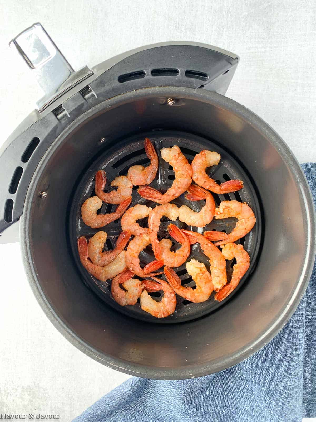 Raw shrimp in air fryer basket