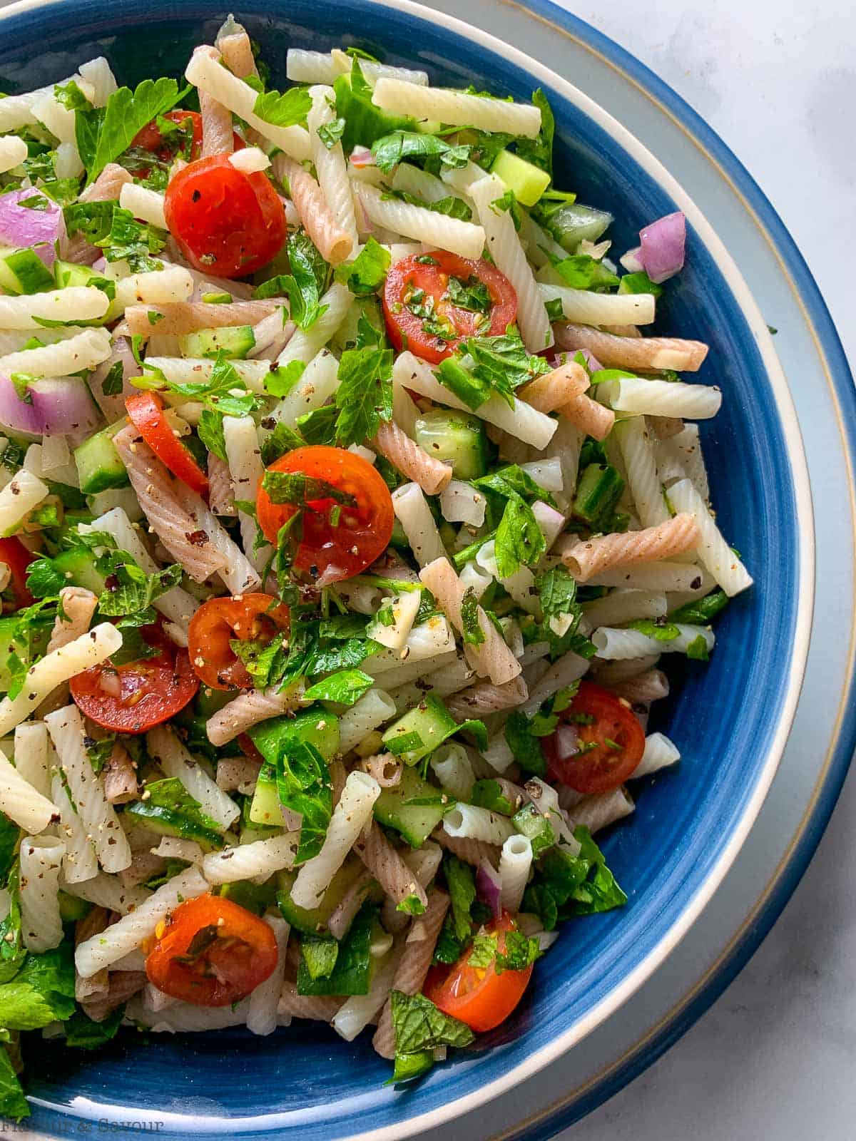 Overhead view of easy tabouli pasta salad in a blue bowl