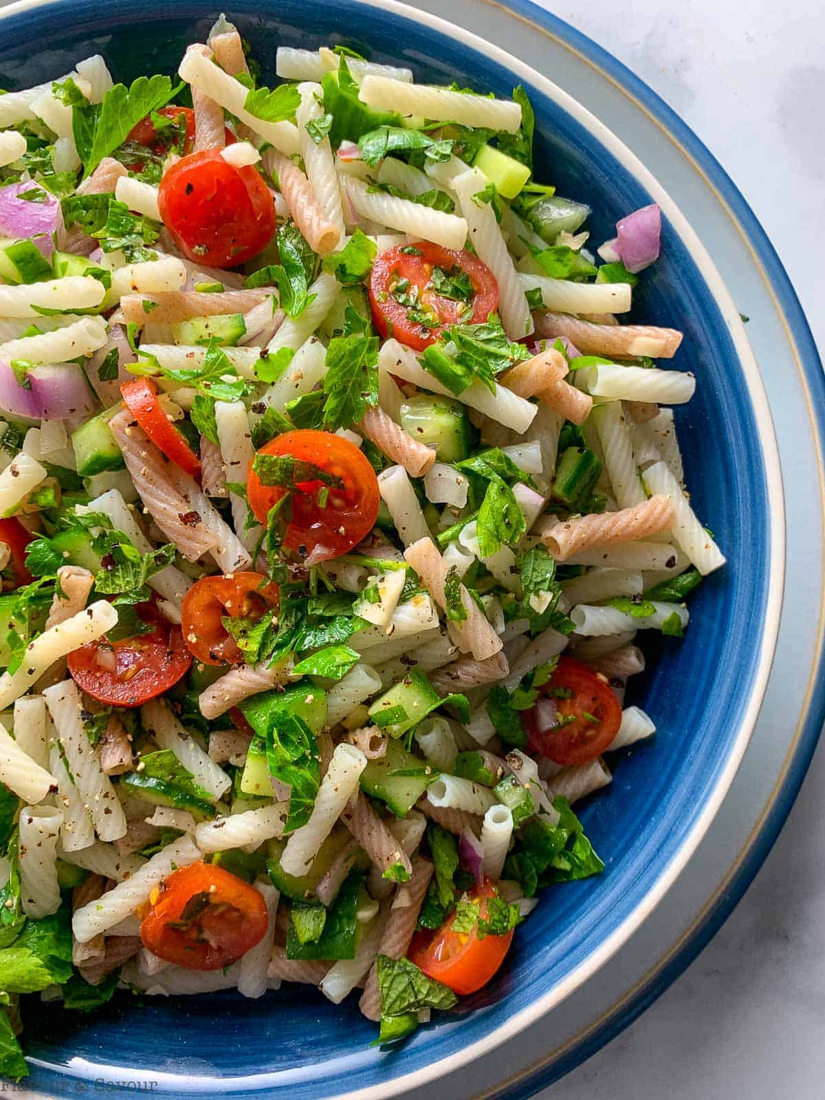 Overhead view of easy tabouli pasta salad in a blue bowl.