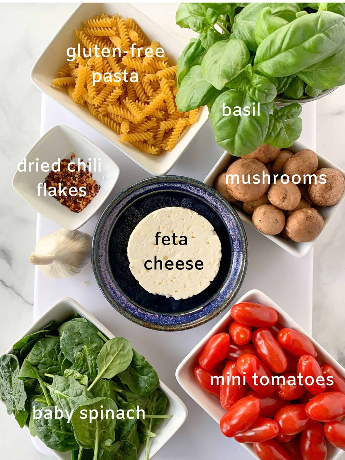 Labeled ingredients for feta tomato pasta bake