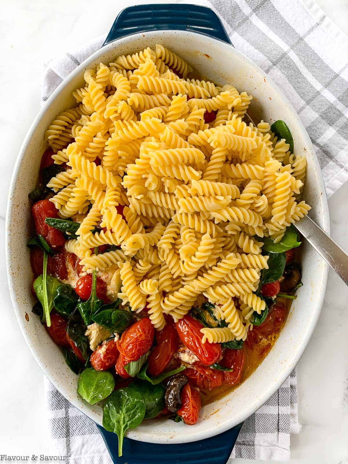 Adding gluten-free pasta to feta pasta tomato bake.