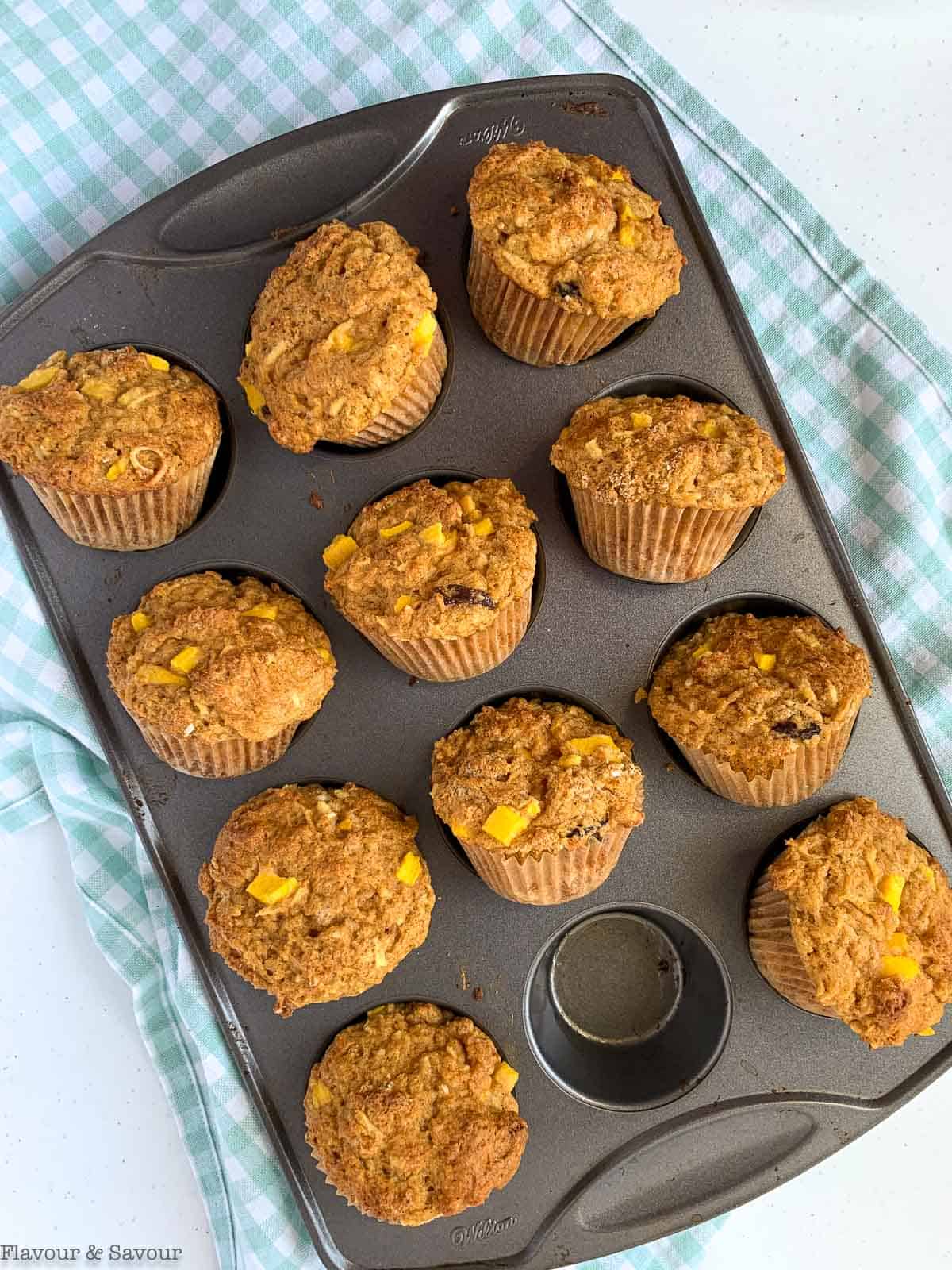 Gluten free mango coconut muffins in a muffin tin