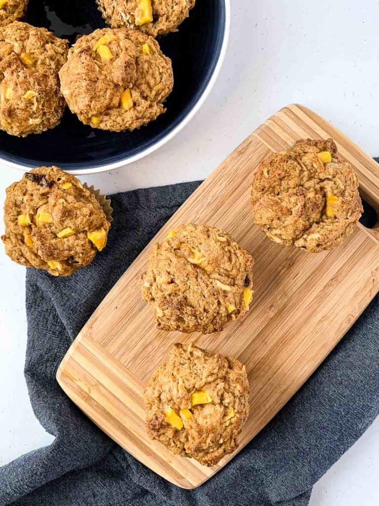 Overhead shot of mango muffins on a board