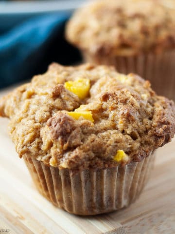 Close up view of a single Gluten-Free Mango Coconut Muffin
