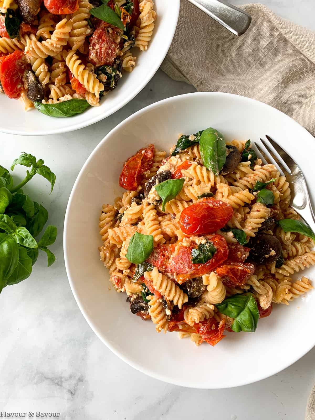 Two bowls of gluten-free feta tomato pasta bake