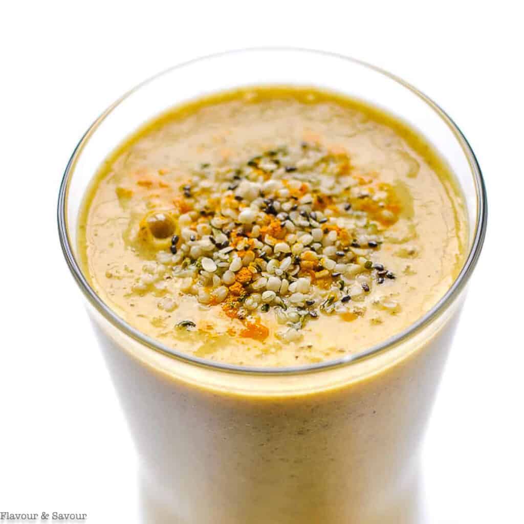 text and close up view of tropical turmeric smoothie with hemp and chia seeds