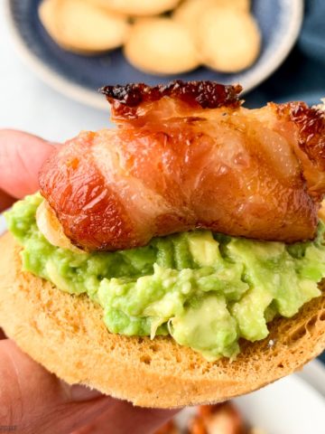 Close up view of a bacon-wrapped shrimp appetizer crostini