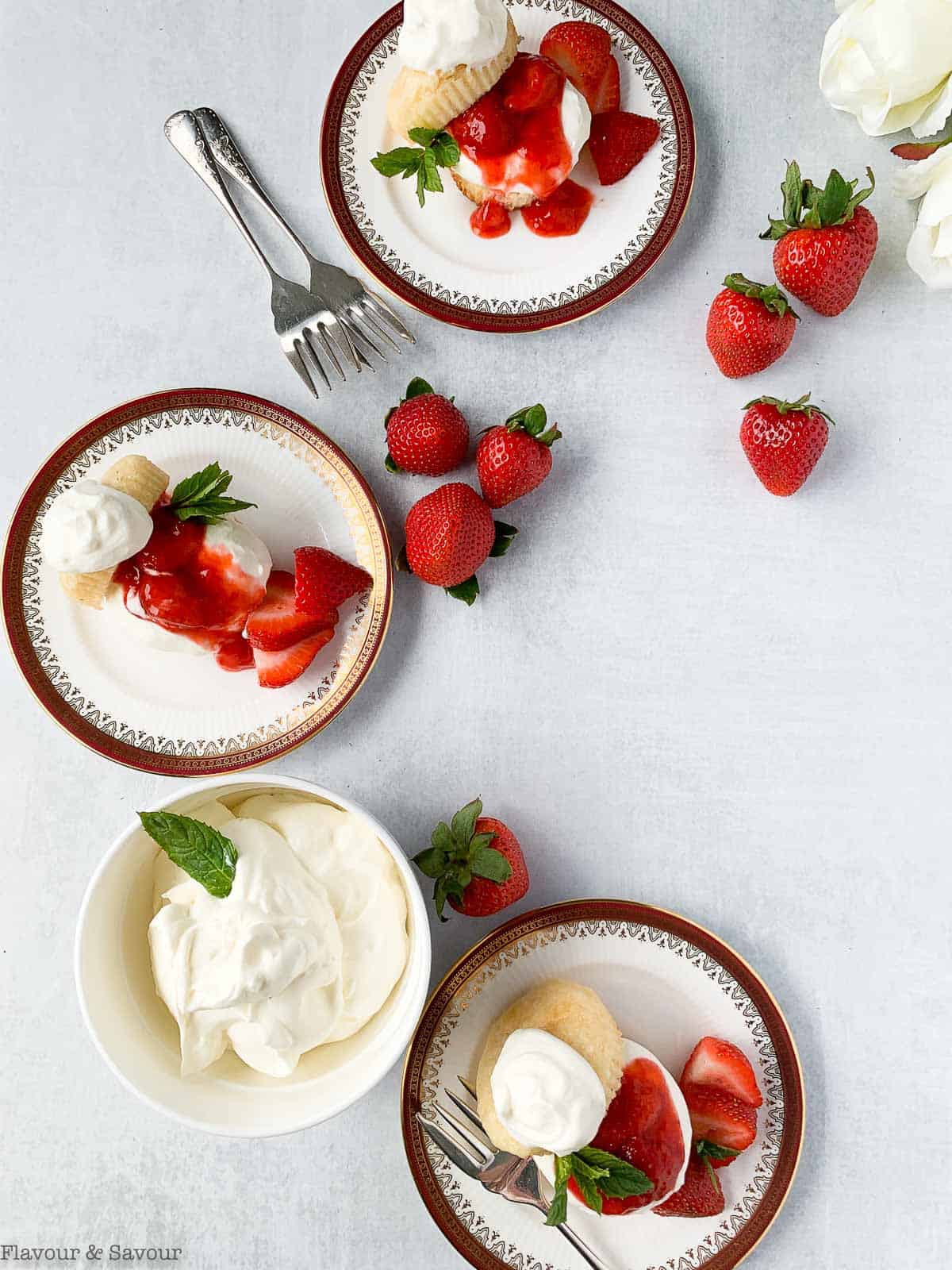 Three dessert plates with strawberry shortcake.