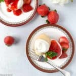 two plates of strawberry shortcake with whipped cream overhead view