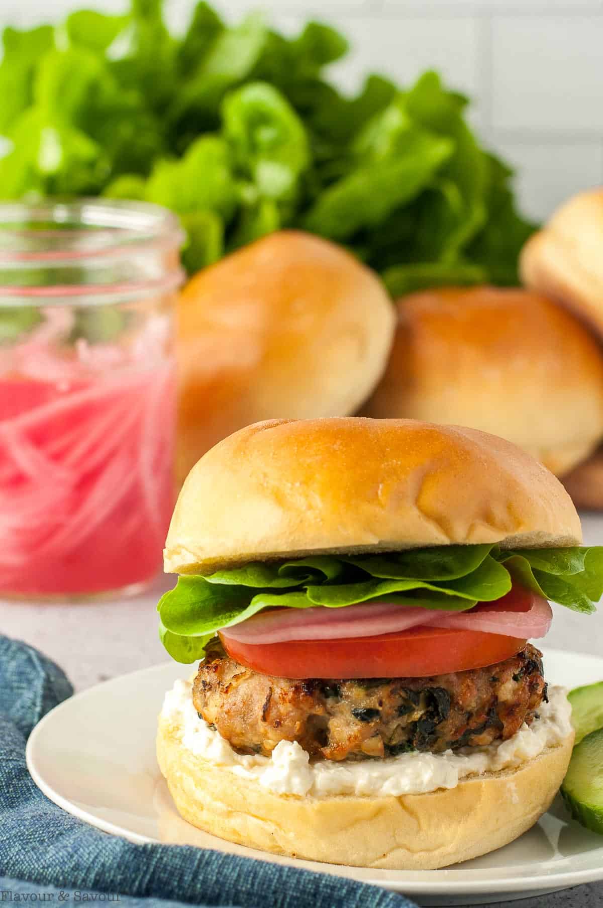 A Greek Chicken Burger made with Feta and Spinach on a bun.