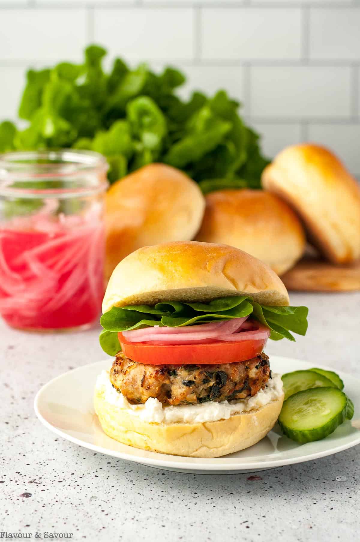 Eye-level view of a Greek Chicken Burger.