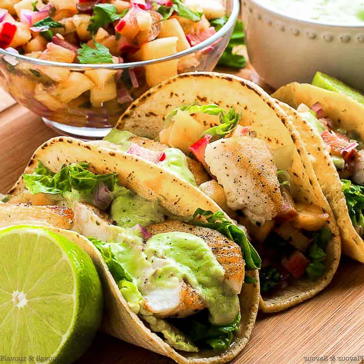 Grilled fish tacos topped with avocado cream.