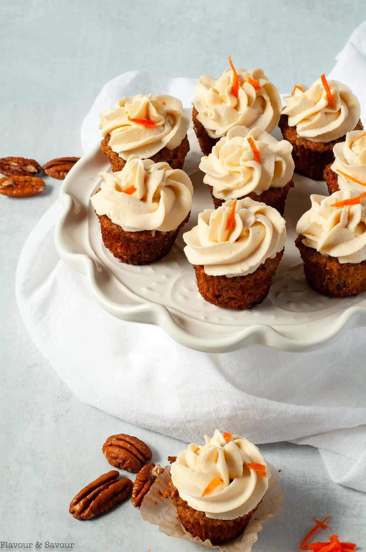 Mini carrot cake cupcakes on a pedestal cake stand.