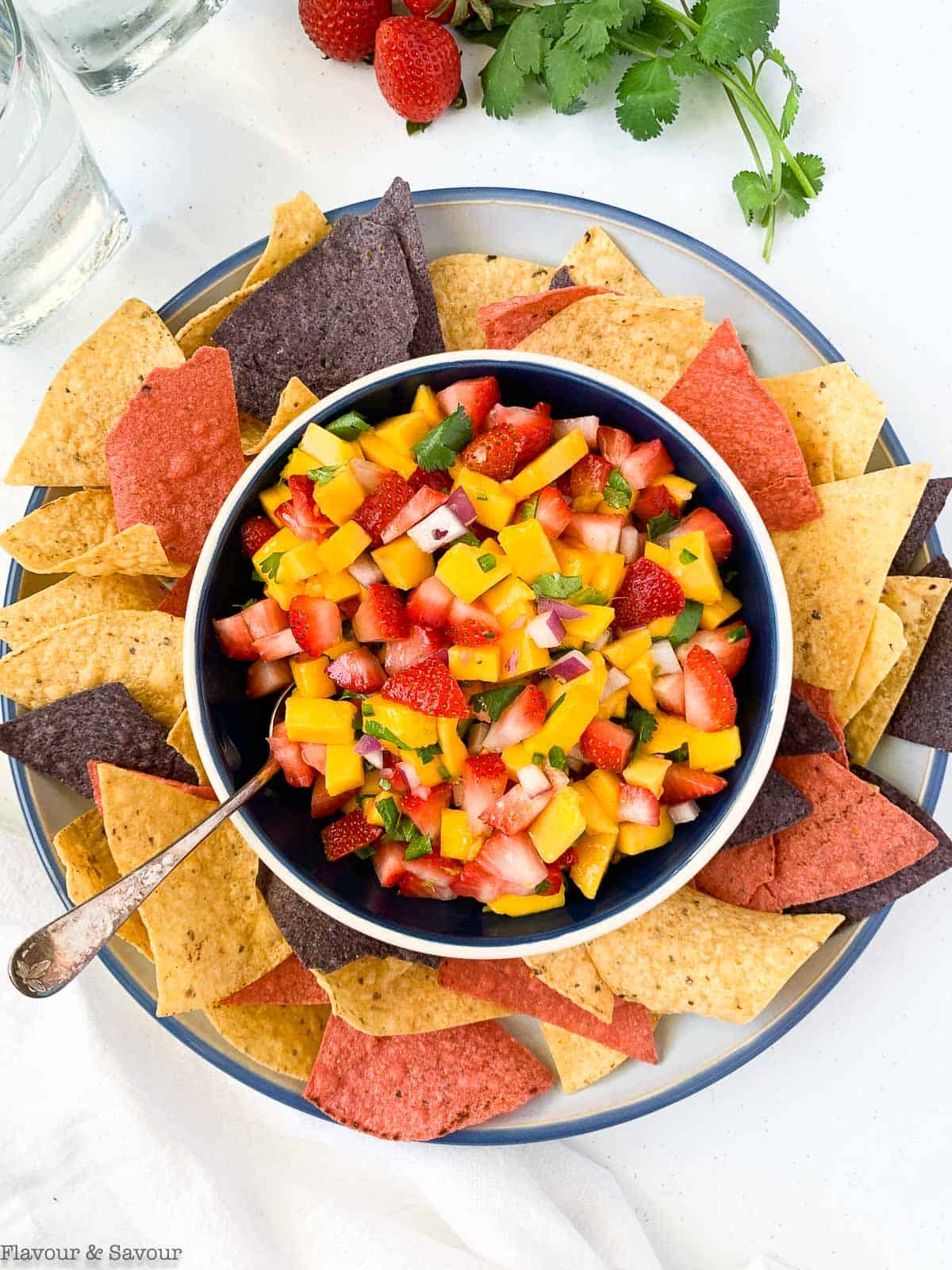 Overhead view of strawberry mango salsa with tortilla chips.