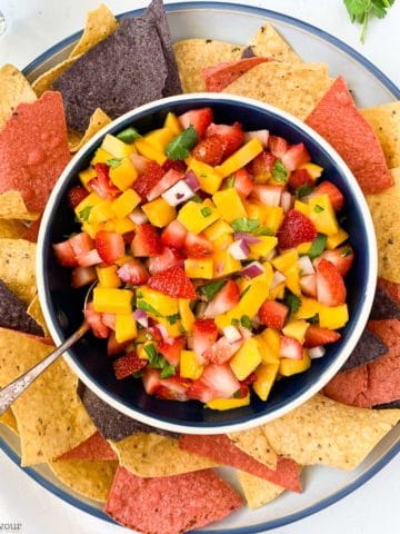 overhead view of strawberry mango salsa surrounded by tortilla chips