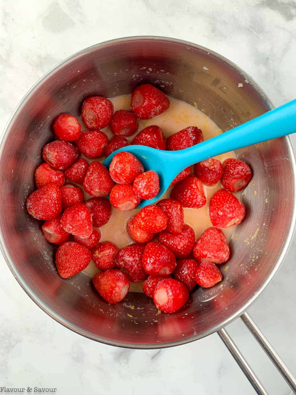 making strawberry sauce for shortcake.