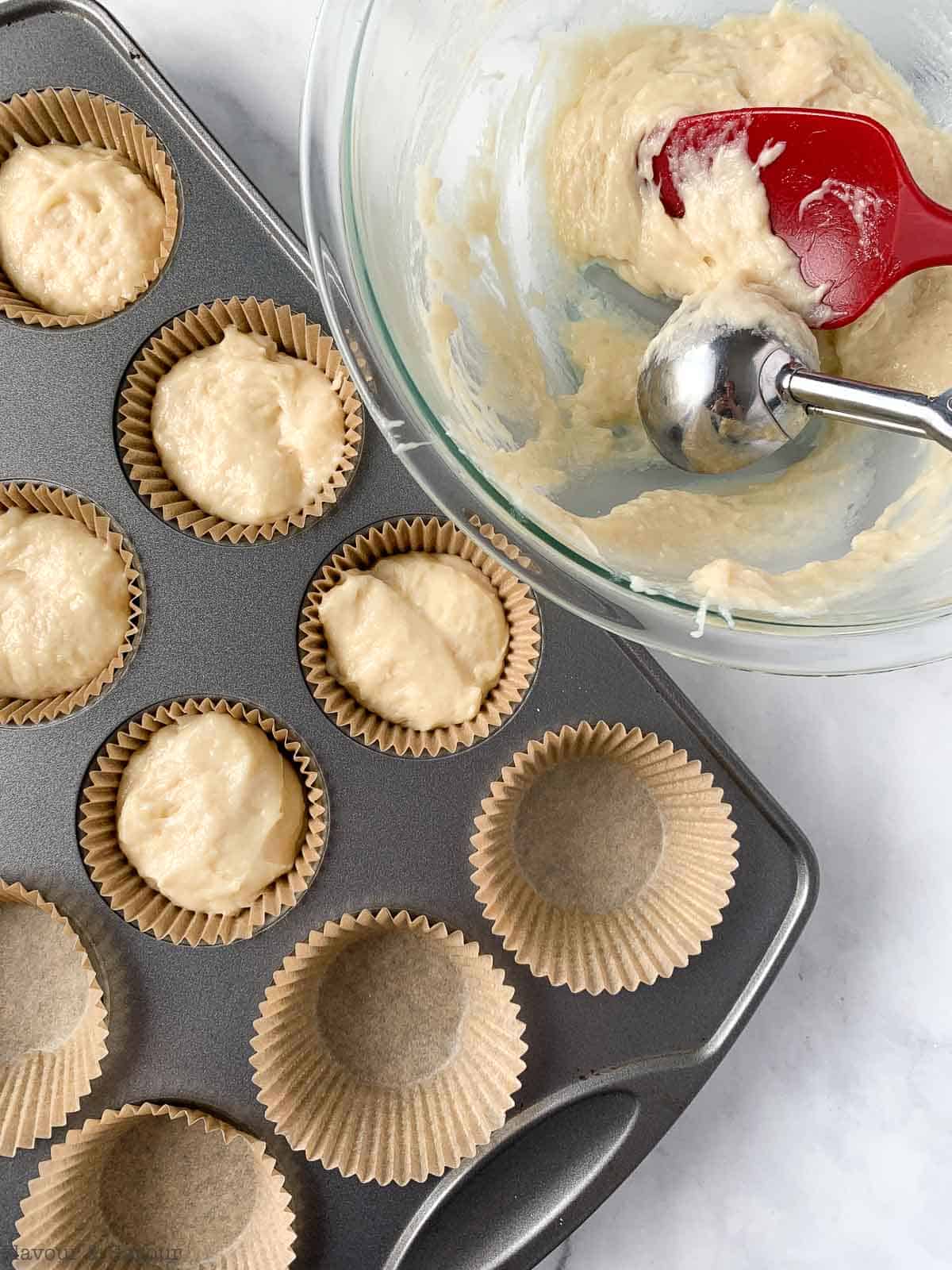 Filling cupcake liners with batter for Strawberry Shortcake