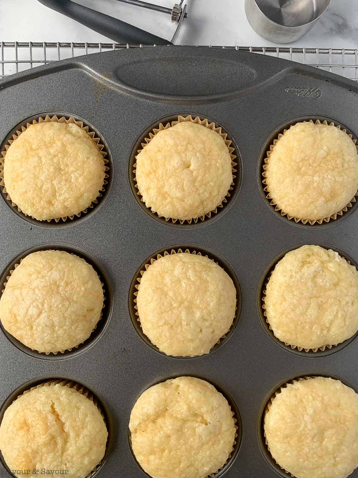 a muffin tin with gluten-free vanilla cupcakes.