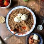 overhead view of gluten-free Strawberry Rhubarb Crisp in a baking dish with ice cream