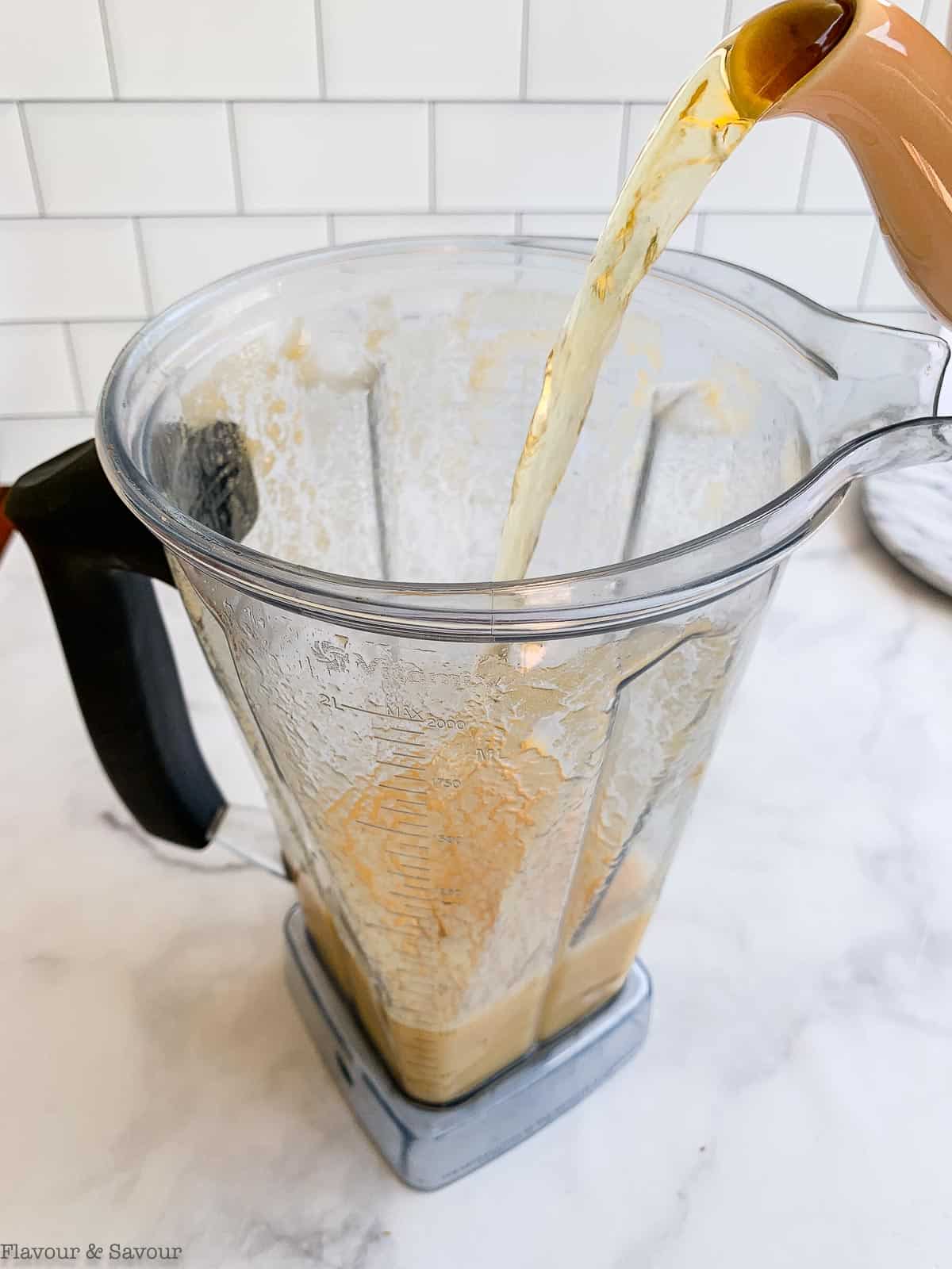 Pouring tea into a blender containe.r