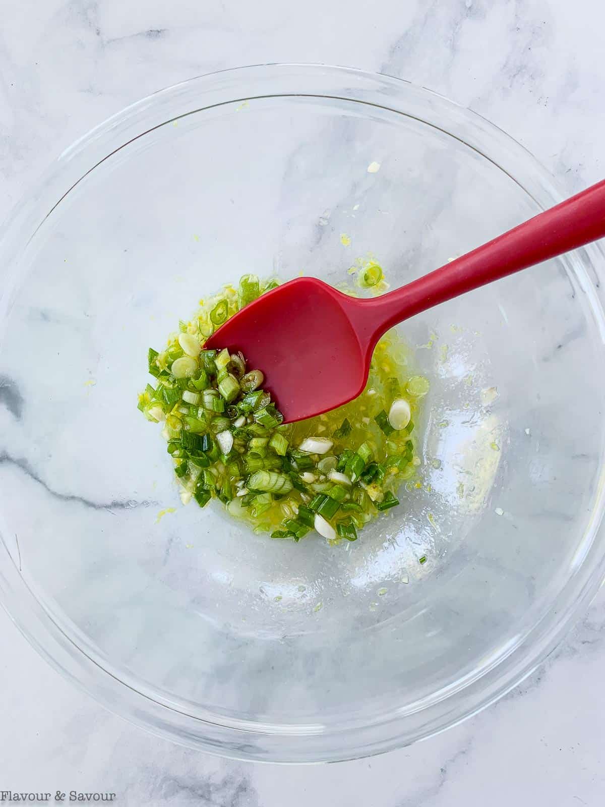 Marinade for lemon garlic potato kabobs in a glass bowl.