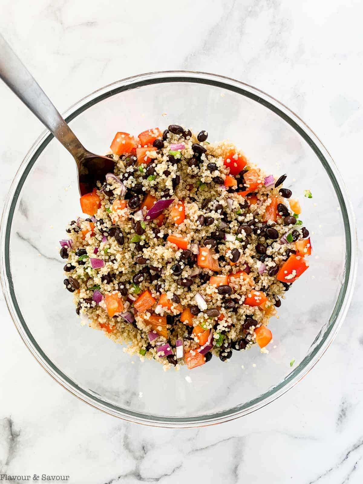 Ingredients for Black Bean Quinoa Salad in a glass bowl.