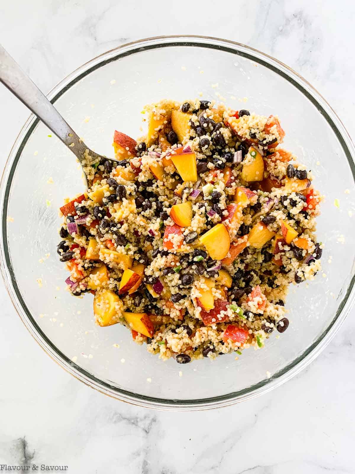 Adding peaches to quinoa black bean salad.