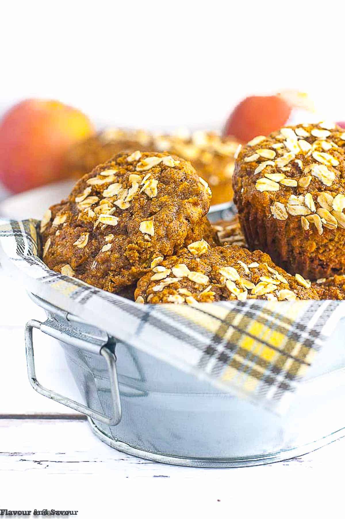 Apple oatmeal breakfast muffins in a bowl with a napkin.