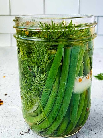 A jar filled with quick refrigerator pickled beans.