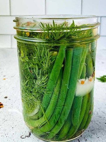 A jar filled with quick refrigerator pickled beans.