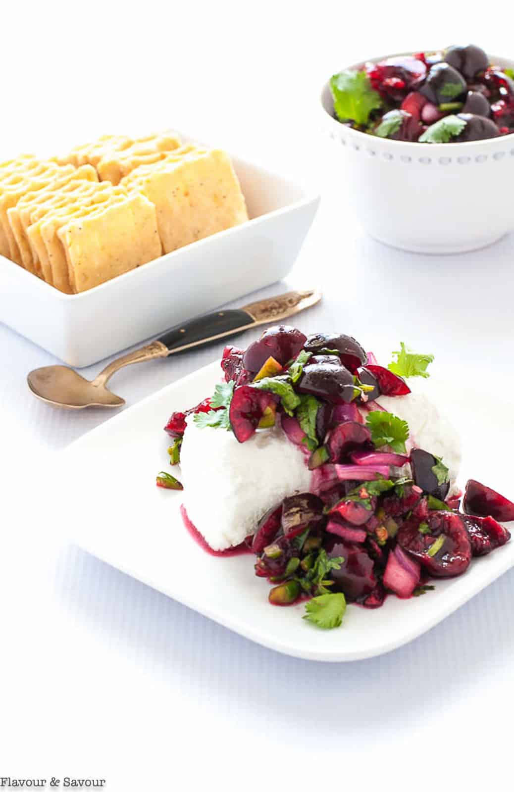 Cherry Salsa on a log of goat cheese with crackers.