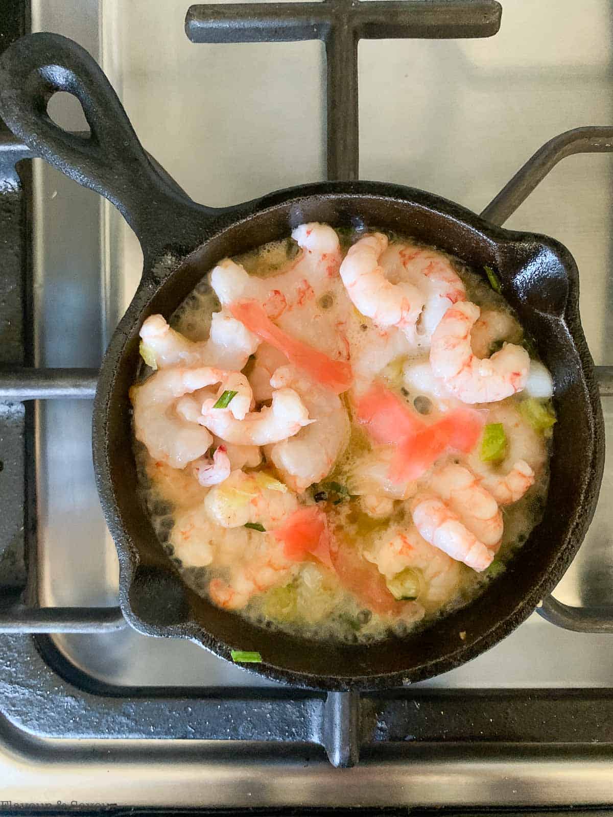 adding pickled ginger to shrimp in skillet