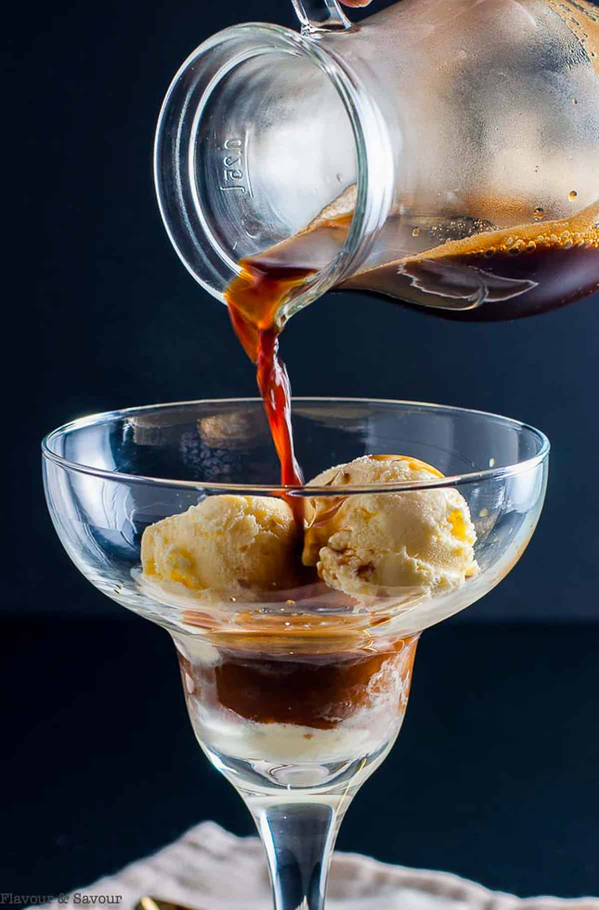 Pouring espresso on gelato to make an affogato coffee ice cream dessert