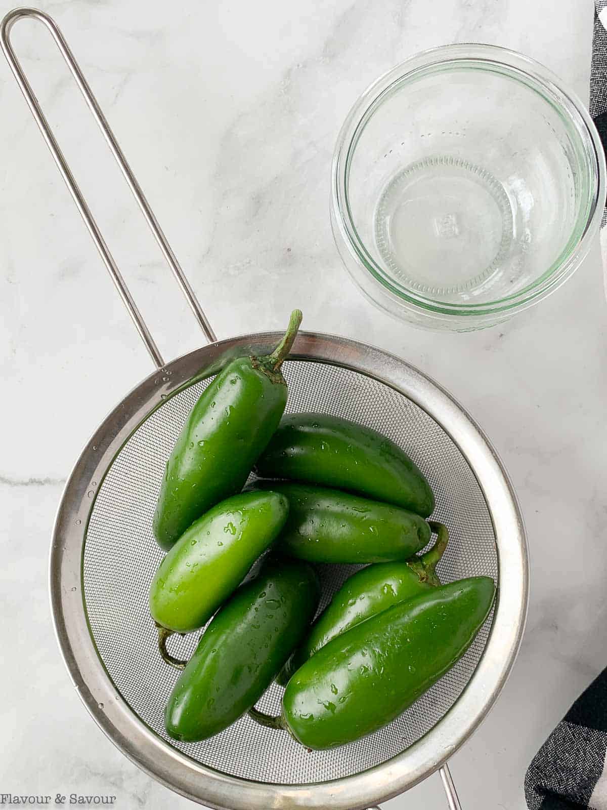 jalapeño peppers in a sieve