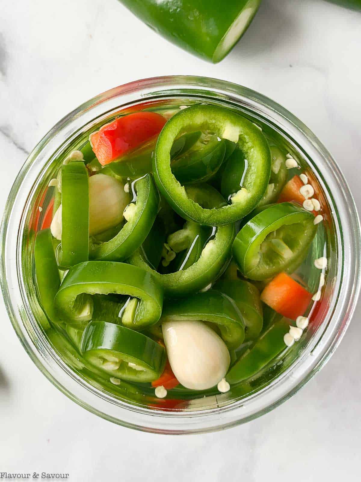 overhead view of a jar of pickled jalapeños