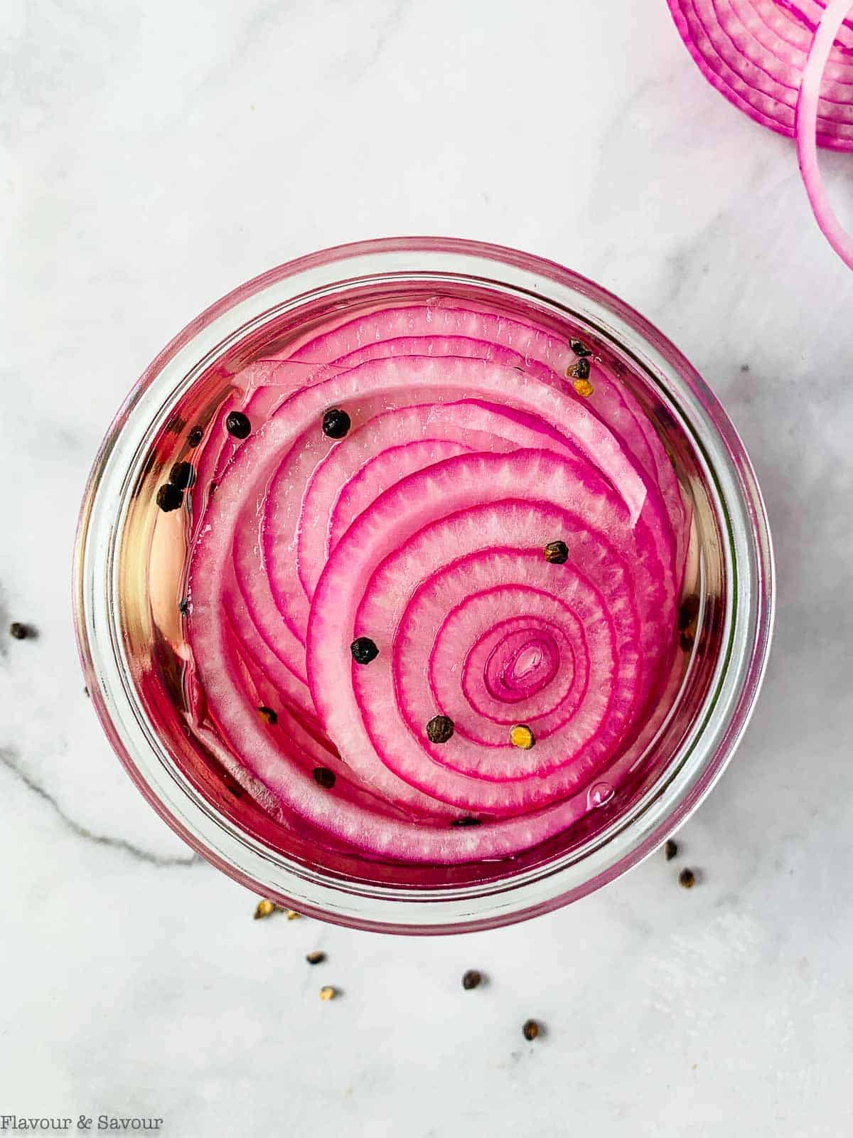 Overhead view of a jar of refrigerator pickled red onions.